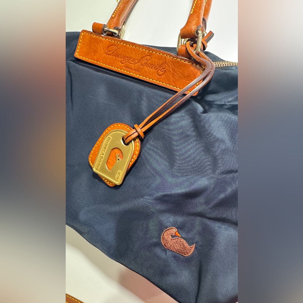 Dooney & Bourke navy nylon bag with hot pink lining. Excellent condition.